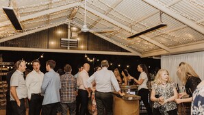 A spacious indoor venue with a high ceiling and exposed beams, featuring a bar area with a counter and seating. - Pet friendly accommodation on the Murray River (Murtho)