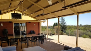An outdoor patio with a dining table, chairs, and a sofa. - Pet friendly accommodation on the Murray River (Murtho)