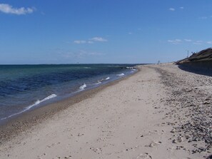 A beach with a clear sky, calm sea, and a sandy shore. - CHARMING HISTORIC ISLAND HOME--WEEKLY RENTAL-- OAK BLUFFS (Oak Bluffs)