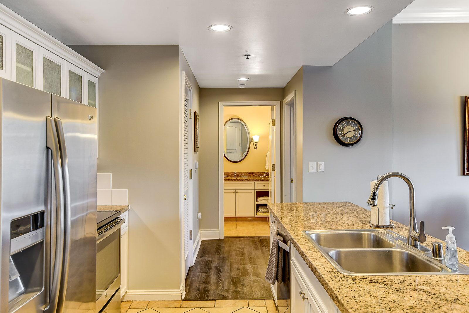 A modern kitchen with stainless steel appliances, a granite countertop, and a double sink.