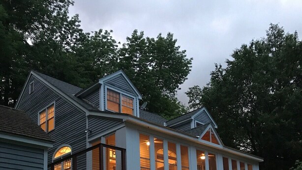 A large, two-story house with a covered porch and string lights. - 5 Bdrm Lakehouse, sleeps 18, private dock, hot tub, 15 minutes to Mount Snow (Wilmington)