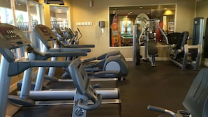 A gym with treadmills, elliptical machines, and weight equipment. - Updated Furniture, 2 Miles To Disney, 3 BD, 3 BA, Private Pool, 5 Stars Resort, (Kissimmee)
