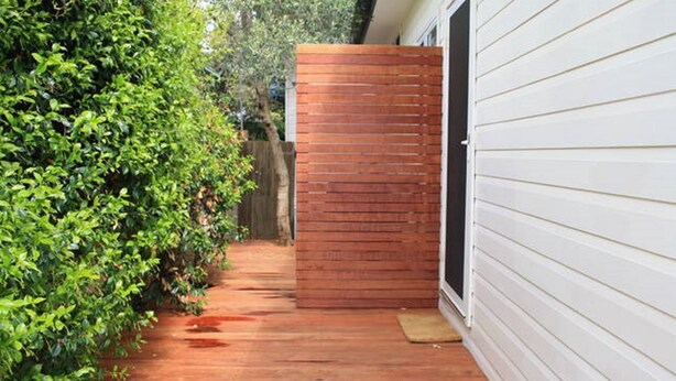 A narrow wooden pathway leading to a wooden gate in a garden area with dense green foliage on one side and a white building on the other. - North Avoca Beach House
200m level walk to beach
4 bedrooms
secure yard (North Avoca)