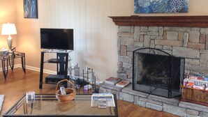 A living room with a stone fireplace, a television on a stand, a lamp, and a painting on the wall. - Stay Where The Stars Stay! And we think everyone who stays with us is a STAR! (Nashville)