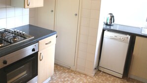 A compact kitchen with a gas stove, oven, and a dishwasher. - Beautiful 2 Bedroom Private Apartment (London)