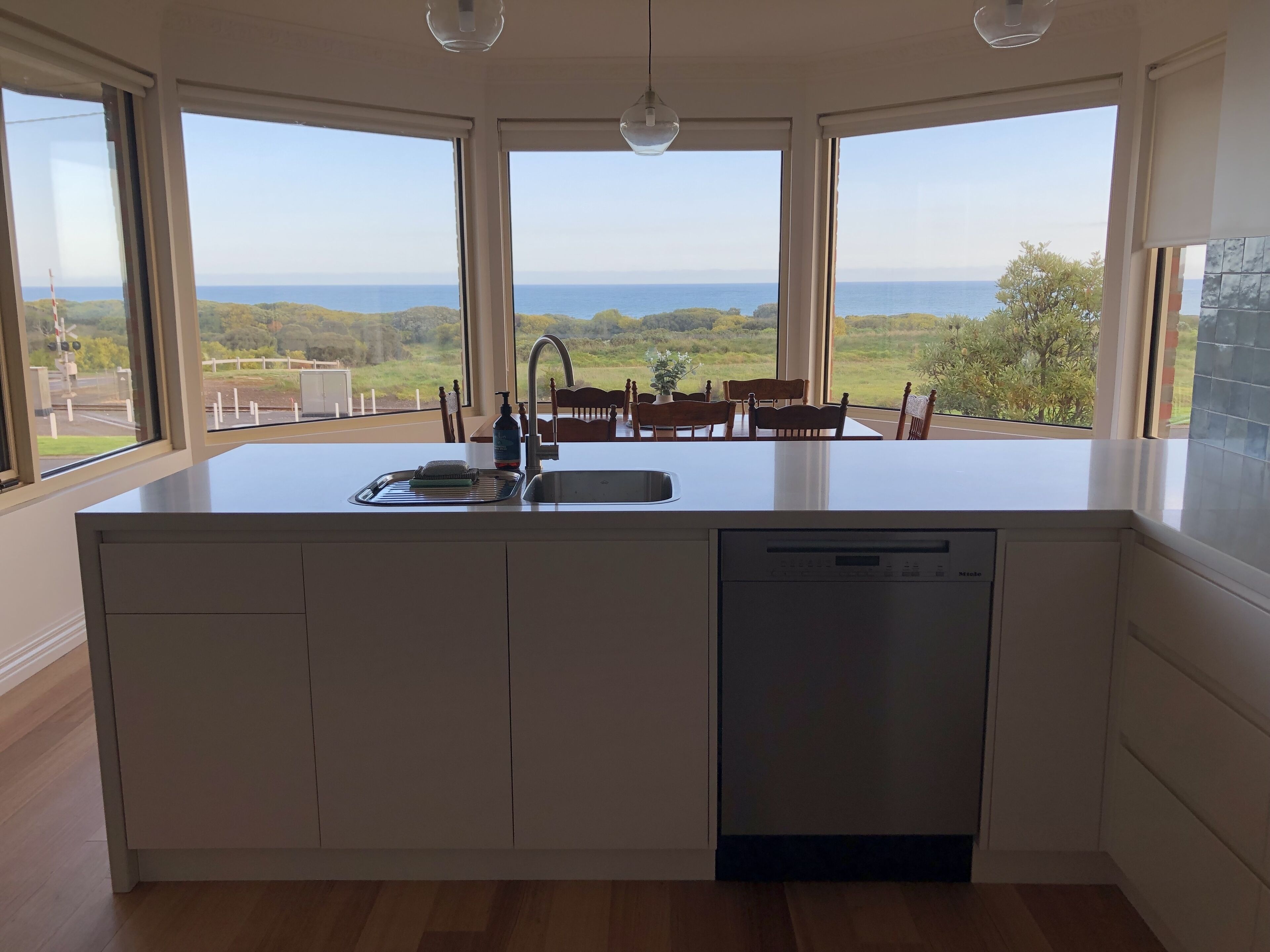 Newly renovated kitchen witn Miele stove and induction cooktop and ocean views