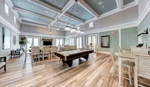 Relax in this spacious room with a pool table, comfortable seating, and stunning views of the outdoors.