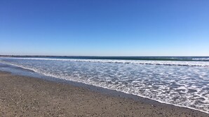 A beach with a clear sky and calm sea.