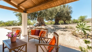 An outdoor patio with wooden furniture and a potted plant. - Trappeto Dellago with pool, parking & wi.fi  (Avola-Noto (siracusa))