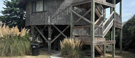 A wooden house with a balcony and a staircase.