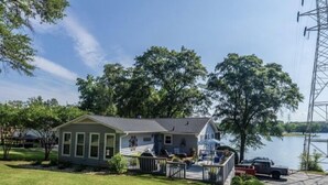 A single-story house with a front porch, a small deck, and a garage. - Lake House with amazing lake views (Inman)
