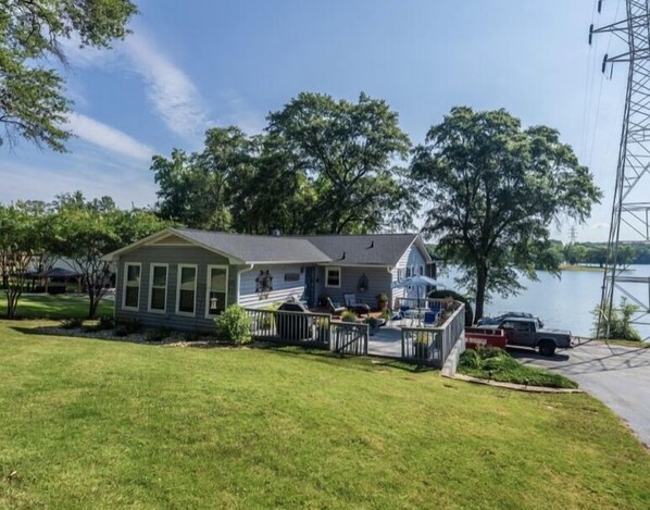 A single-story house with a front porch, a small deck, and a garage. - Lake House with amazing lake views (Inman)