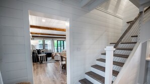 A staircase with wooden steps and white railings leading to a second floor. - Salty but Sweet - 3 min walk to Beach - Newly Renovated - Video! (Wells)