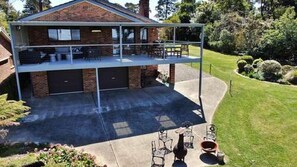 A two-story house with a balcony, a garage, and a well-maintained lawn. - Hat Hill Hideaway Amazing Valley Views (BLACKHEATH)