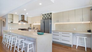 Enjoy cooking in this well-equipped kitchen with a central island, stainless steel range, and oven.