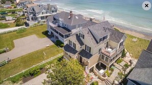 A large, multi-story house with a spacious backyard and a balcony overlooking the beach. - Beachfront Property on Private Moody Beach (Wells)