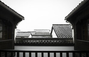 A traditional building with a tiled roof and wooden railings.