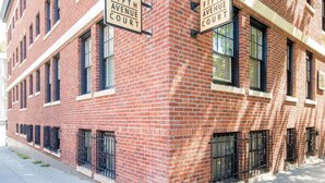 A red brick building with two signs reading "Fifth Avenue Court". - Quiet Flat. Vibrant Neighborhood! Walk to Pike Place, great restaurants & more. (Seattle)