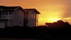 A two-story house with a balcony, surrounded by vegetation. - All About the View North 3 bedroom oceanfront (Bandon)