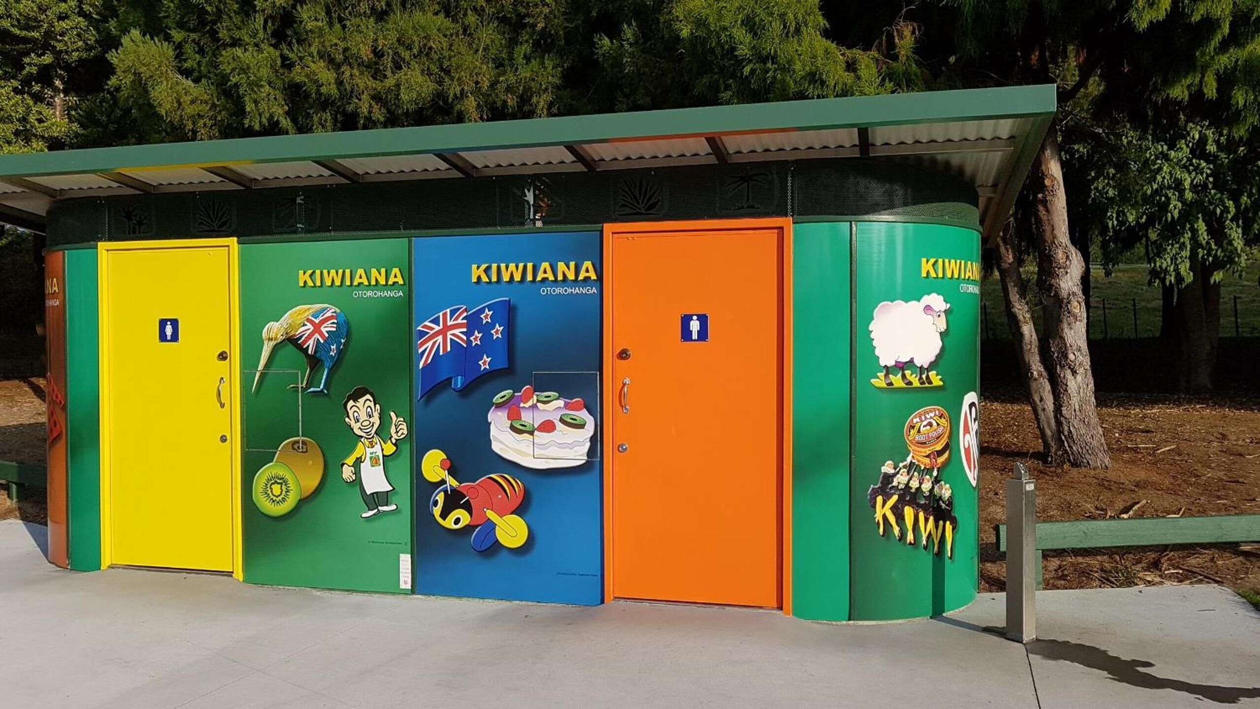 A row of colorful portable toilets with national flags and kiwi fruit illustrations.