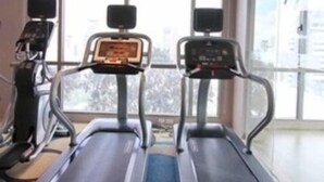 A fitness room with treadmills and a stationary bike.