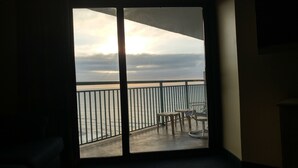 A balcony with a view of the sea, a table, and chairs. - Panoramic Views from spacious 3 BR 2 BA condo (Myrtle Beach)