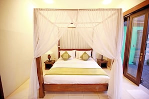 Relax in a serene bedroom with a four-poster canopy bed, complete with a wooden frame and comfortable bedding.