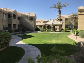Stroll through the serene courtyard, surrounded by lush greenery and a tranquil gazebo.