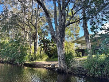 The house is on the Noosa river system in 4 acres of bush. Bush parks on 3 sides