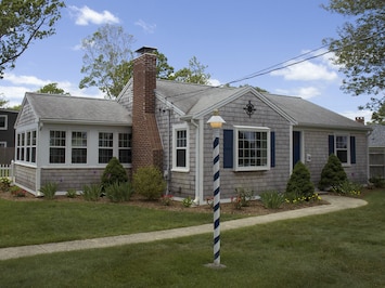 Falmouth Heights Cottage is a grey-shingled classic built in 1950 & updated 2015