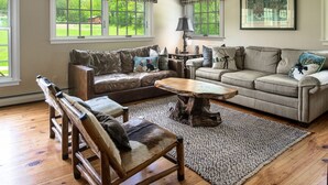 A cozy living room with two sofas, a wooden coffee table, and a rug. - Private Family Estate for any Season - Hermitage Club/Inn (West Dover)