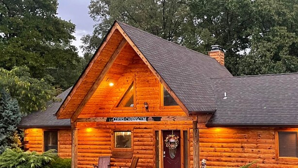 A log cabin with a front porch, a chimney, and a sign reading "CODYS CABINS.COM". - Timber Mountain Lodge,  Private Hot Tub .1 Mi to Thunder Ridge; 10 min Branson  (Ridgedale)