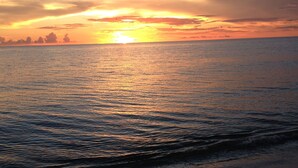A sunset over a calm sea with gentle waves. - Great Unit On Marco River (marco island)