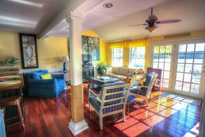 A living room with a sofa, armchairs, a coffee table, and a television. - Lake Front Paradise Sleeps 8 (East Haddam)