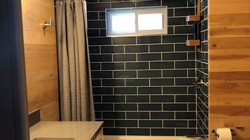 Combined shower/bathtub, hair dryer, towels, toilet paper