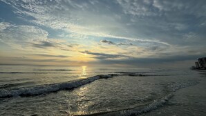 A beach with waves and a sunset. - Spacious 3 Bedrm/2 Bth OceanFront Apt w/Large Balcony Overlooking Pool. Sleeps 9 (Daytona Beach Shores)