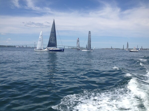 A sailboat with a large sail and a smaller sail on the deck, sailing on a body of water.