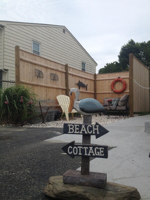 A wooden fence with a life preserver and a fish decoration.