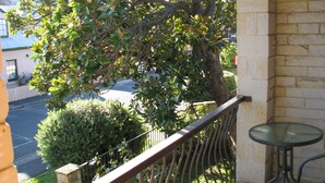 A balcony with a view of a street and a tree. - API Leisure & Lifestyle Battery Point (Battery Point)