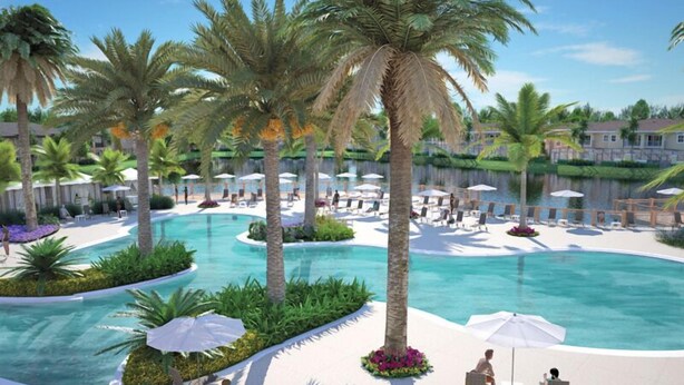 A resort pool area with palm trees, lounge chairs, and umbrellas. - 3 BR/3BH, 3 miles to Disney, Gates Resort, Pool with Water Slides (Kissimmee)