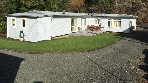 A single-story mobile home with a patio and a small lawn.
