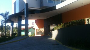 A multi-story building with a modern architectural design, featuring balconies and large windows. - Luxurious apartment with a 5-star style water park near HOT PARK. (Rio Quente)