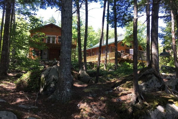 Cabin and garage room view from lake. dock. It is a WOW