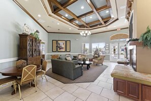 Cozy living area with a dining table, sofa, and TV, perfect for relaxing and socializing.