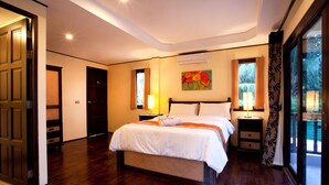 A bedroom with a large bed, a nightstand, a window with curtains, and a painting on the wall.