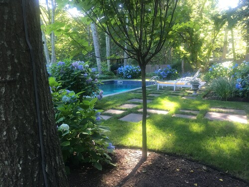 5.5 miles to U.S. Open! Swim in a sea of hydrangeas on this bucolic property.