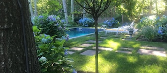 5.5 miles to U.S. Open! Swim in a sea of hydrangeas on this bucolic property.