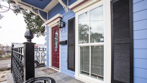 A house with a blue exterior, a red door, and a large window with shutters. - TOP LOCATION! Luxury Traditional New Orleans Home, Heart of NOLA (New Orleans)