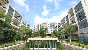 A modern apartment complex with multiple balconies, a central courtyard, and surrounding greenery. - Baan Nub Kluen Condo - Hua Hin (Tambon Nong Kae)