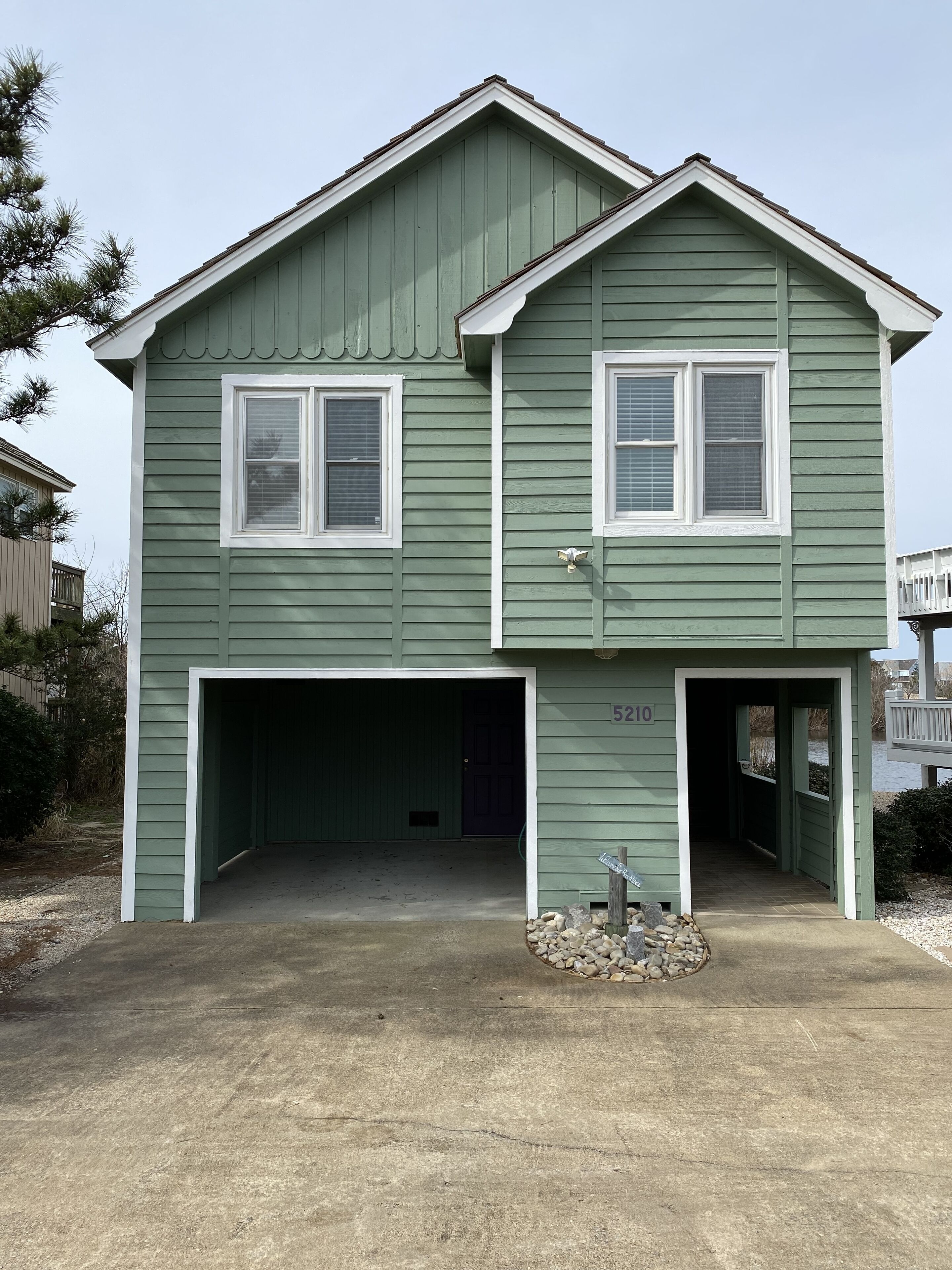 A two-story house with a garage and a driveway.